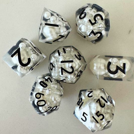 Set of clear dice with black numbers on a light gray background