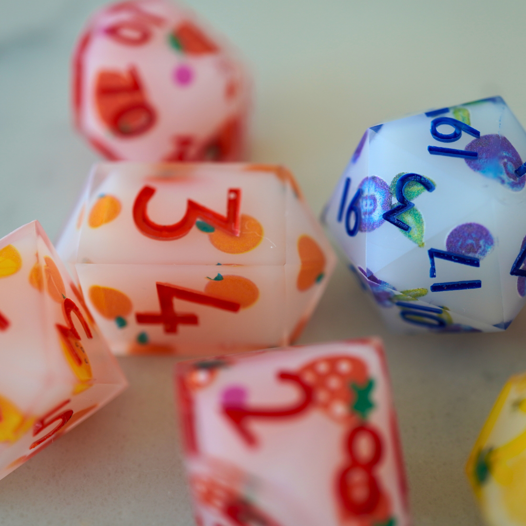 Colorful fruity dice with numbers and patterns on a light background