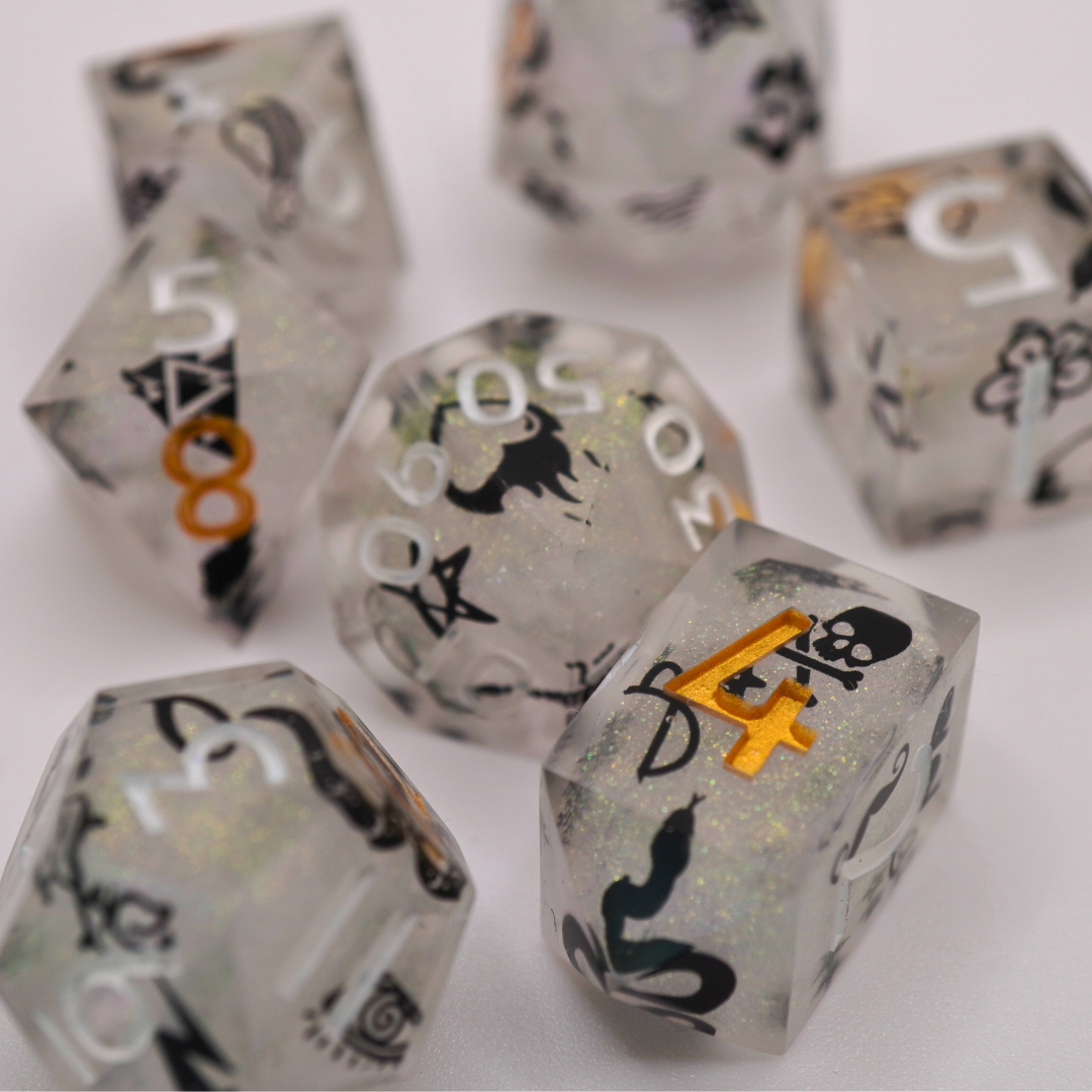 Clear dice with black and orange designs on a white background